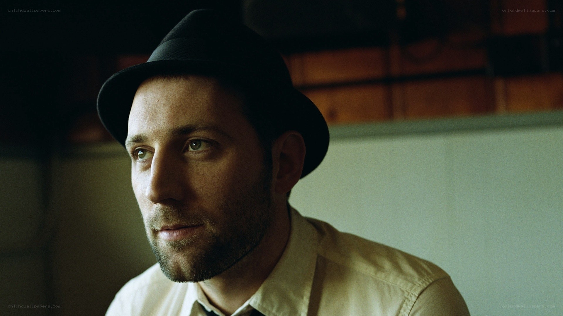 man in hat looking away