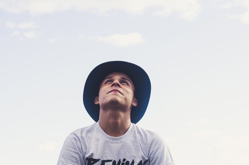 man in hat looking up