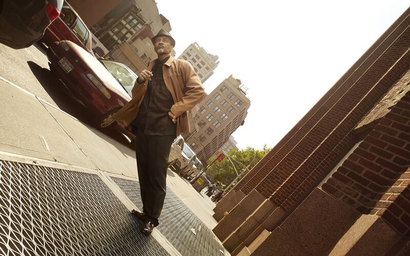 Man in hat on city street
