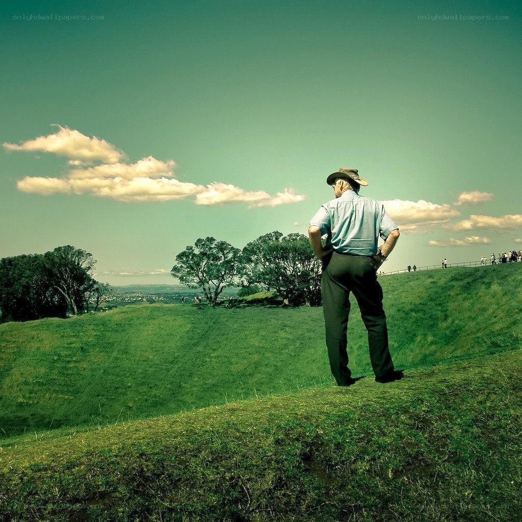 Man in hat on grassy hill