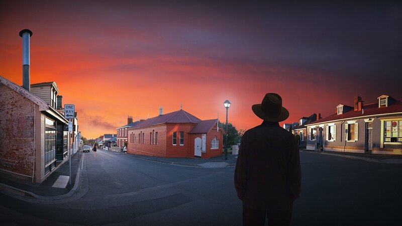 Man in Hat on Street — Orange
