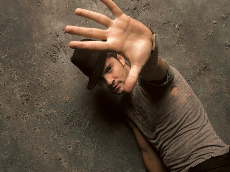 Man in Hat Reaching Out