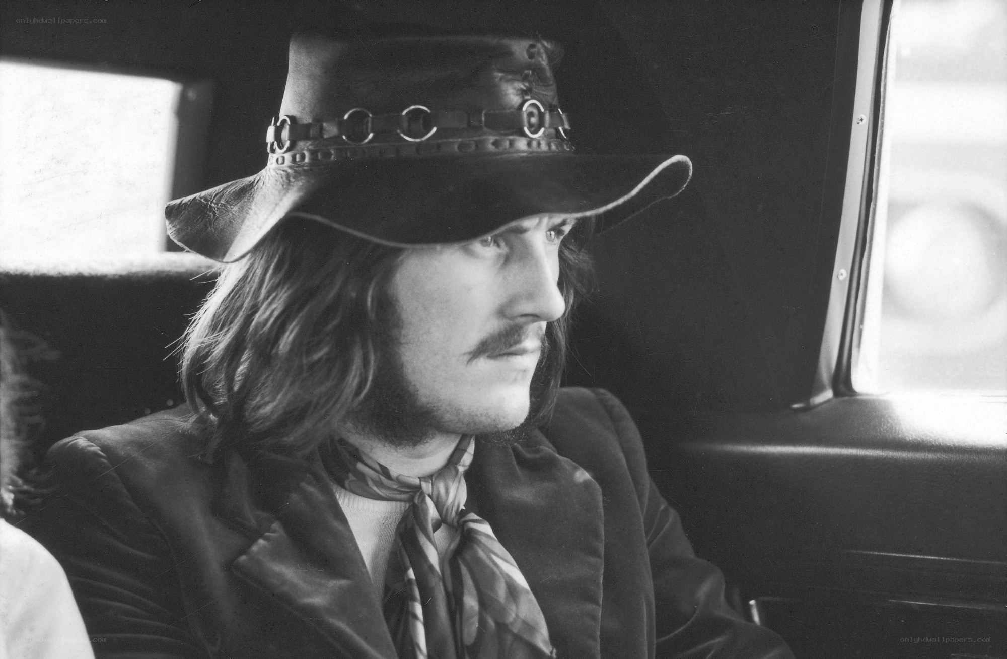 Man in hat sitting in car