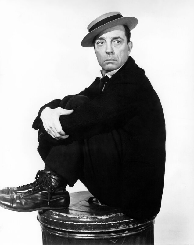 Man in hat sitting on barrel
