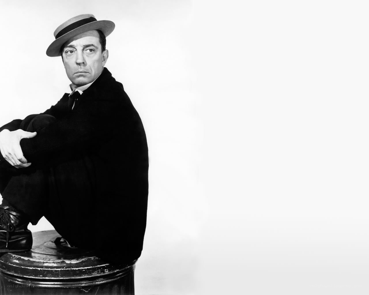 man in hat sitting on barrel