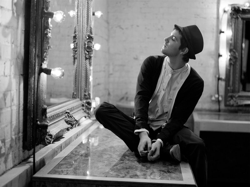man in hat sitting on vanity