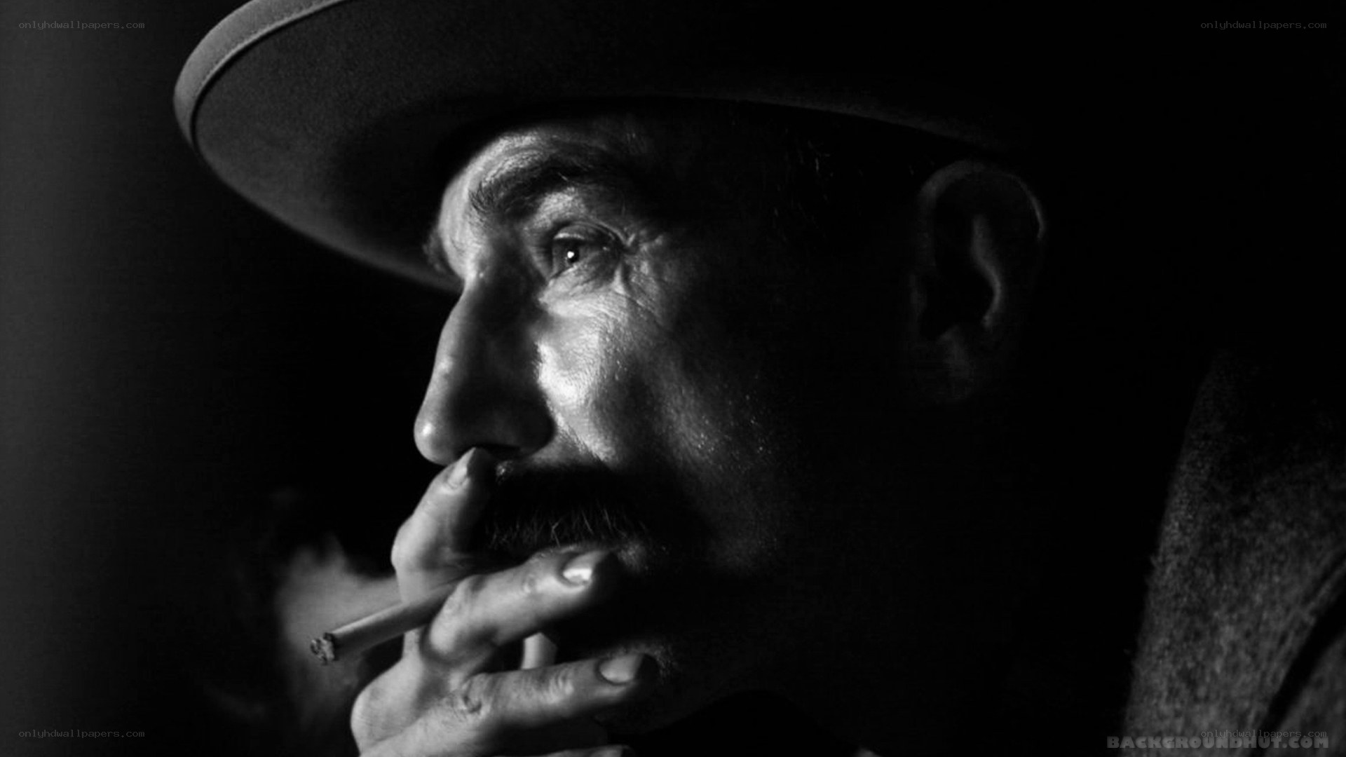 man in hat smoking cigarette
