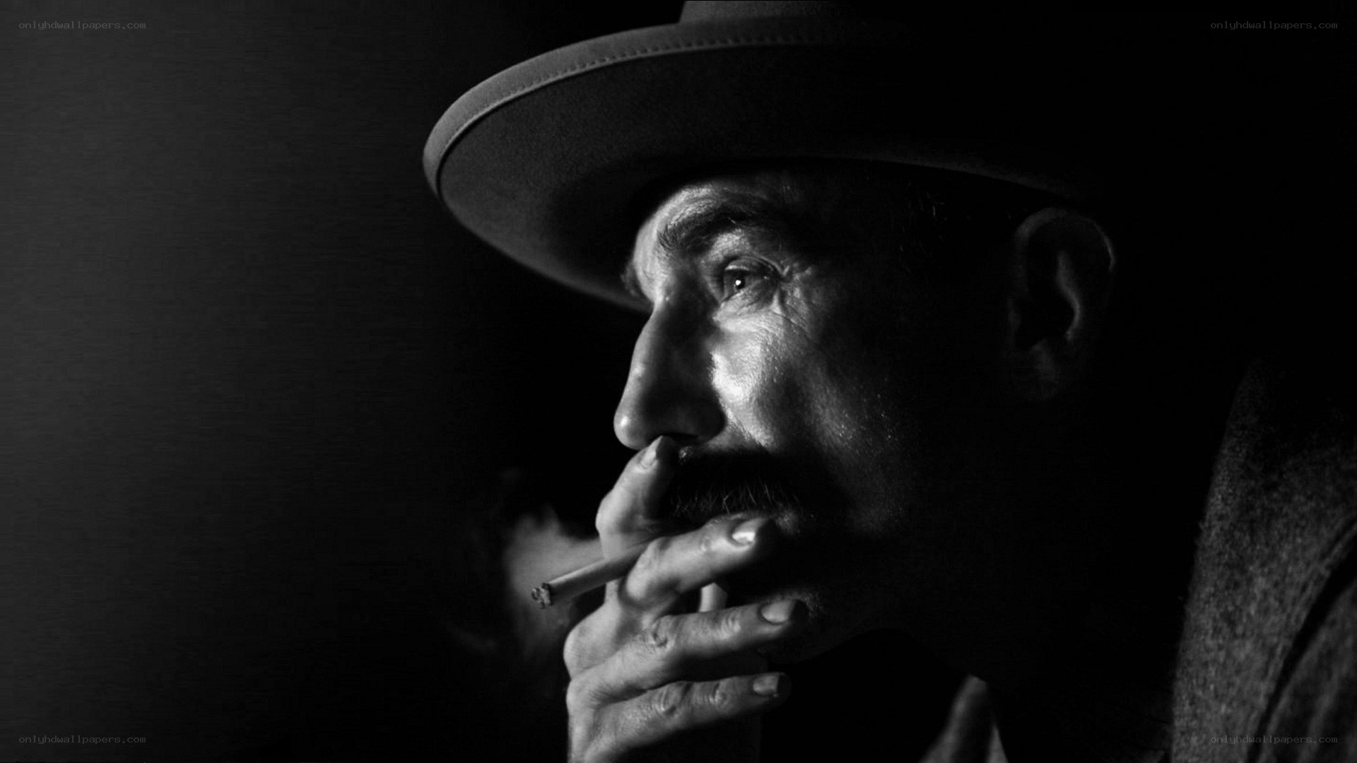 man in hat smoking cigarette