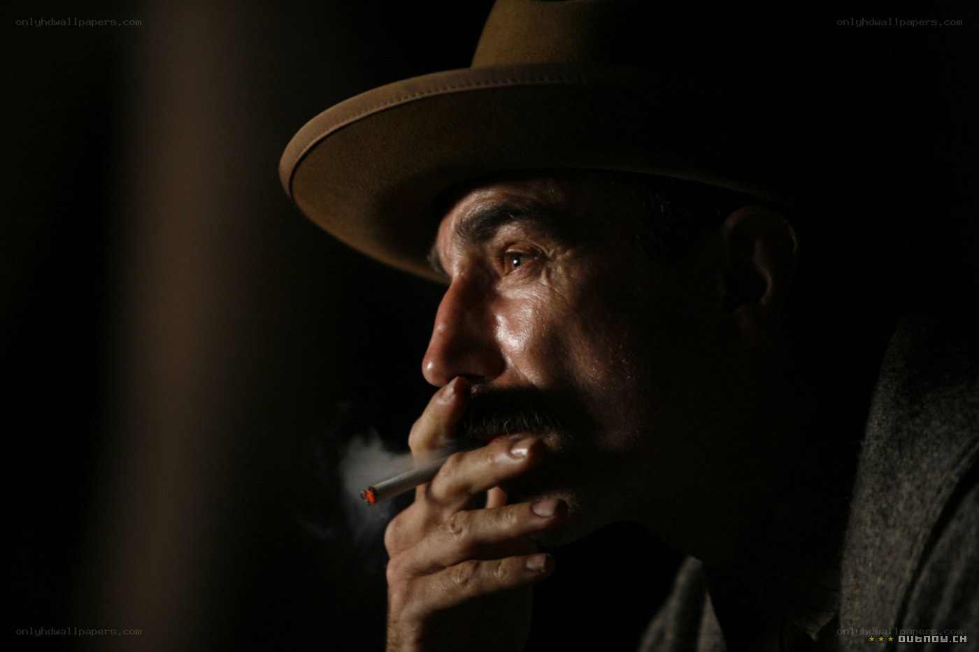 man in hat smoking cigarette