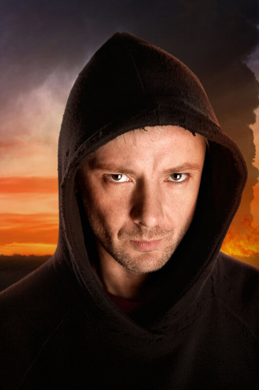 man in hood against sunset