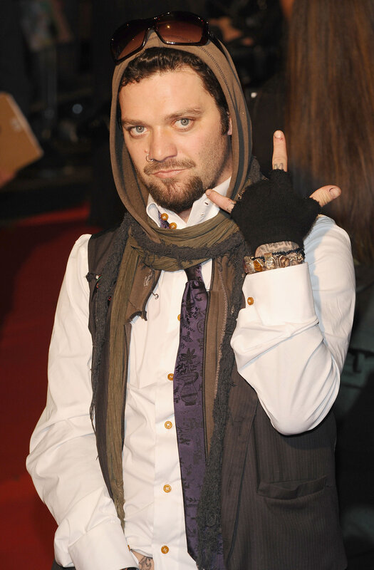 man in hooded vest on red carpet