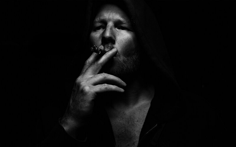 man in hoodie smoking cigar