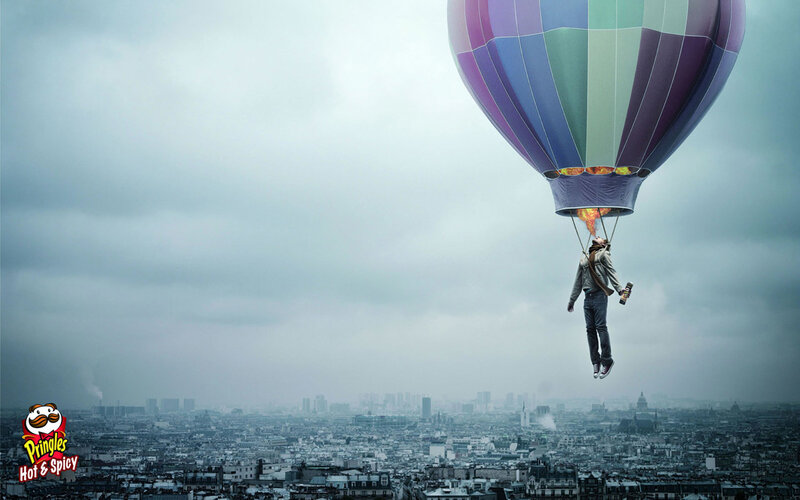 Man in hot air balloon over city
