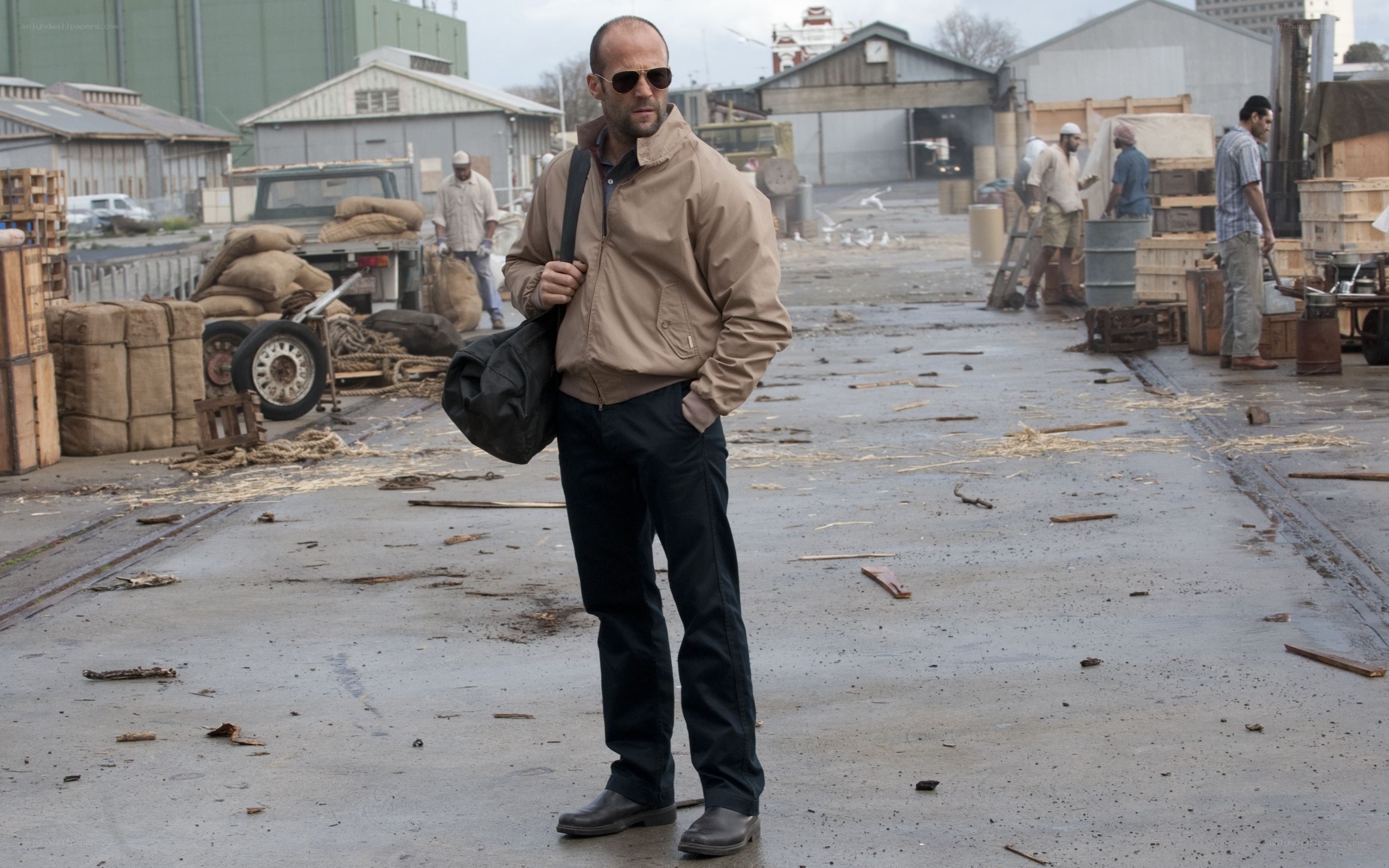 Man in jacket at industrial yard