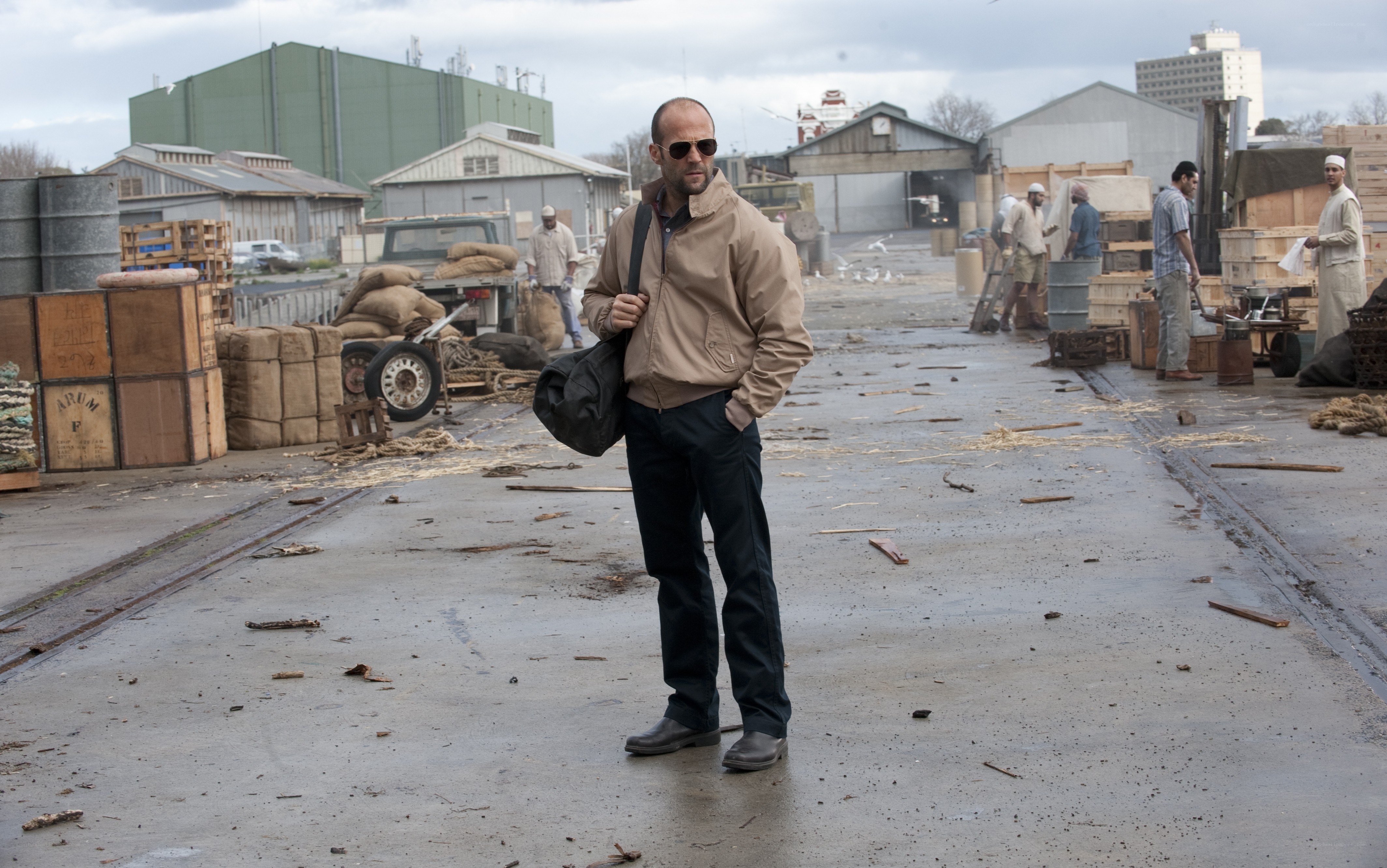 Man in jacket at industrial yard