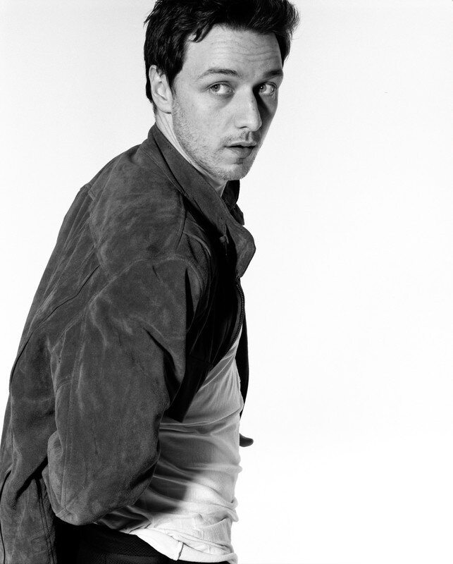 man in jacket looking over shoulder