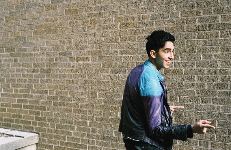 man in jacket pointing at wall