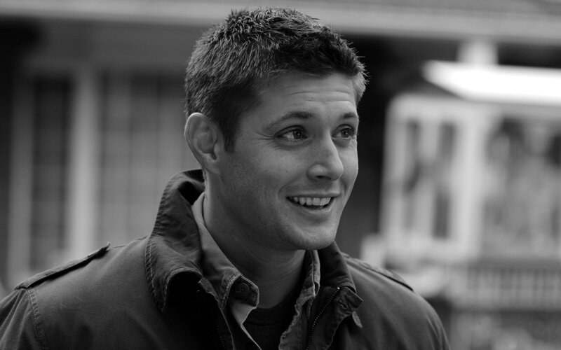 Man in Jacket Smiling — Black, Neutral