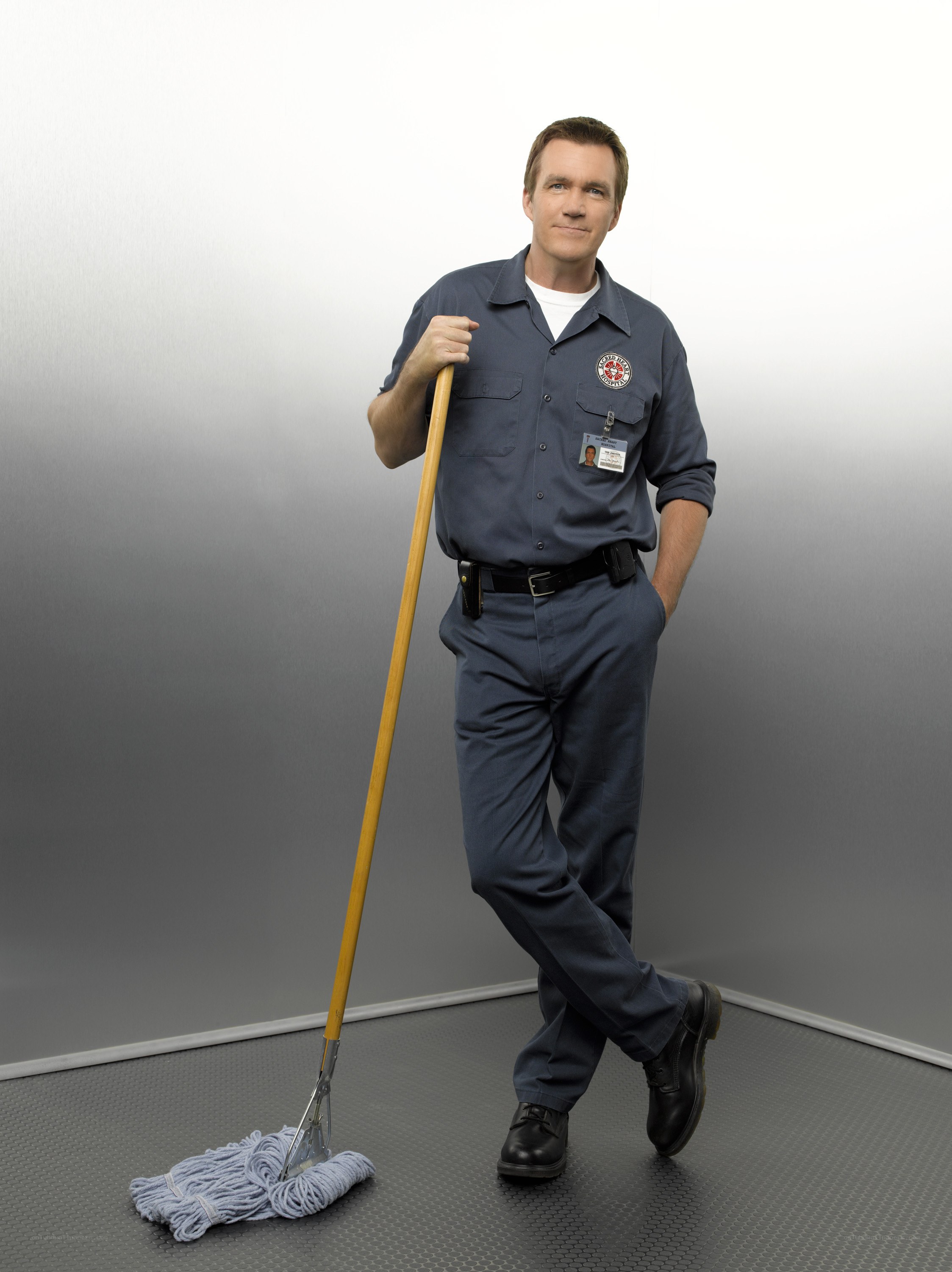 man in janitor uniform with mop