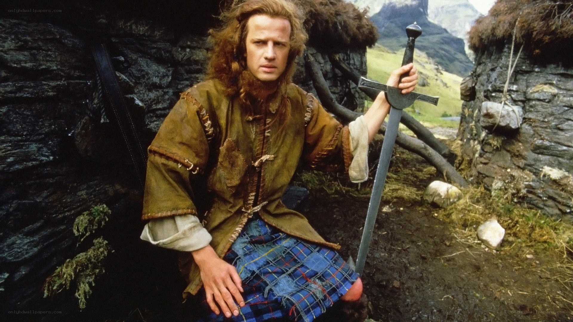 man in kilt holding sword