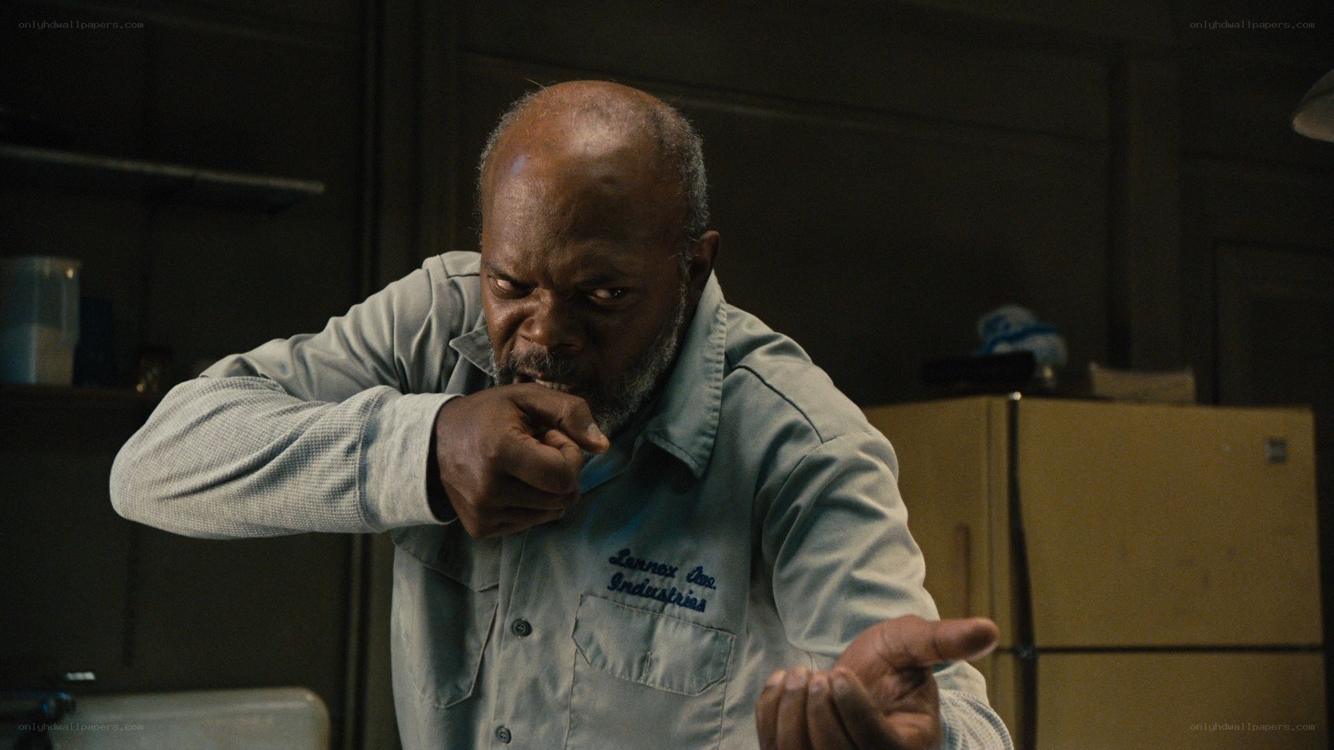 man in kitchen making fist