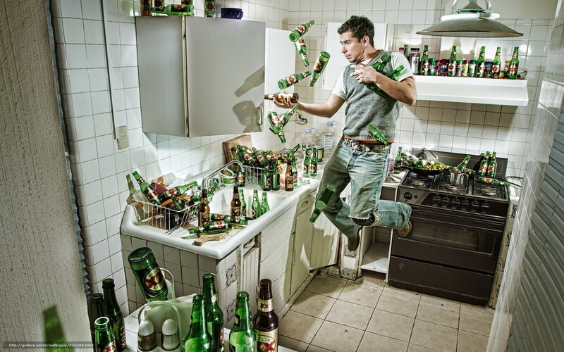 Man in kitchen with beer bottles