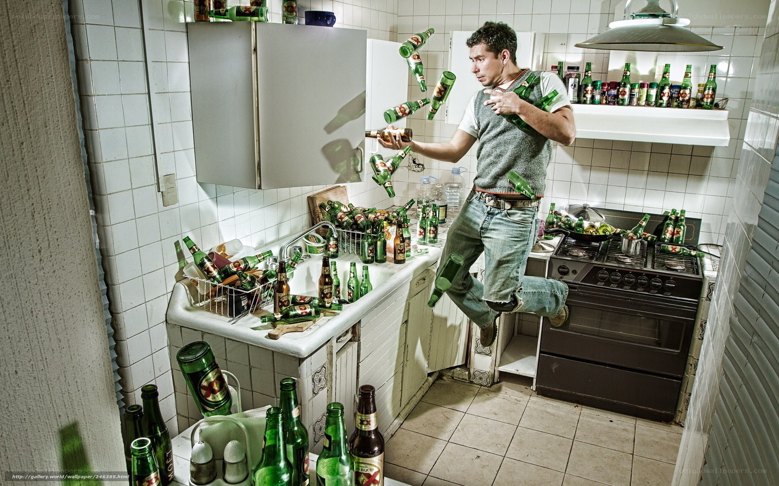 Man in kitchen with beer bottles