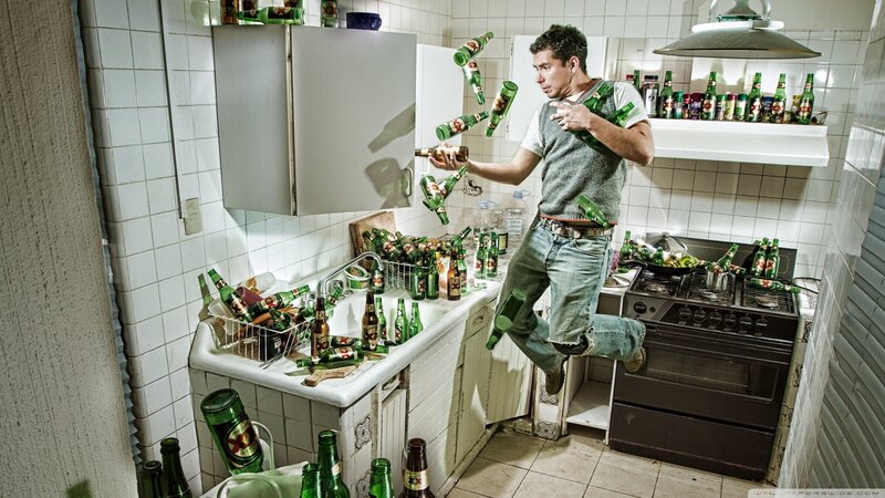 Man in Kitchen with Bottles