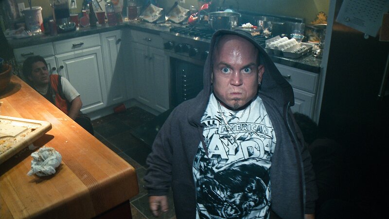 Man in kitchen with shocked expression