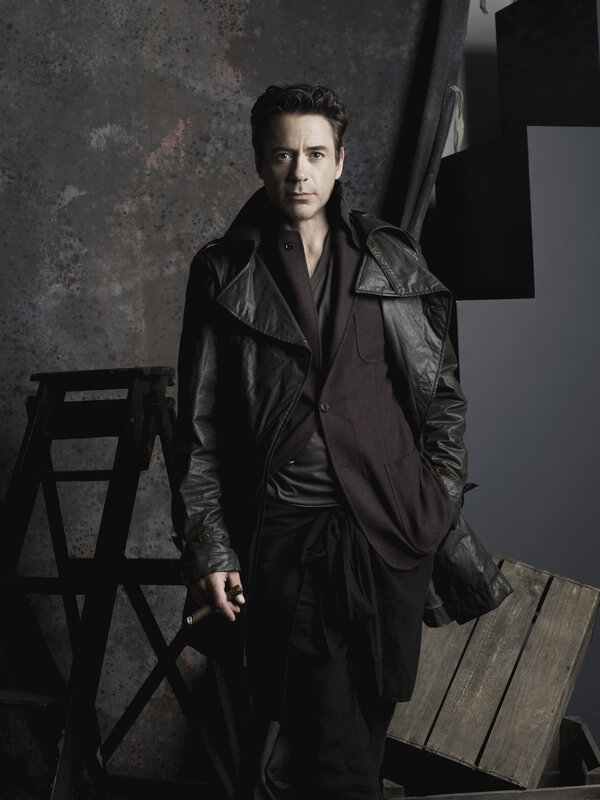 man in leather coat holding cigar