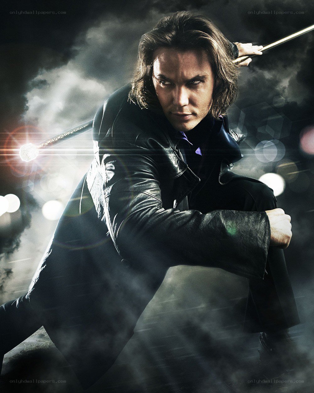 Man in leather coat with staff