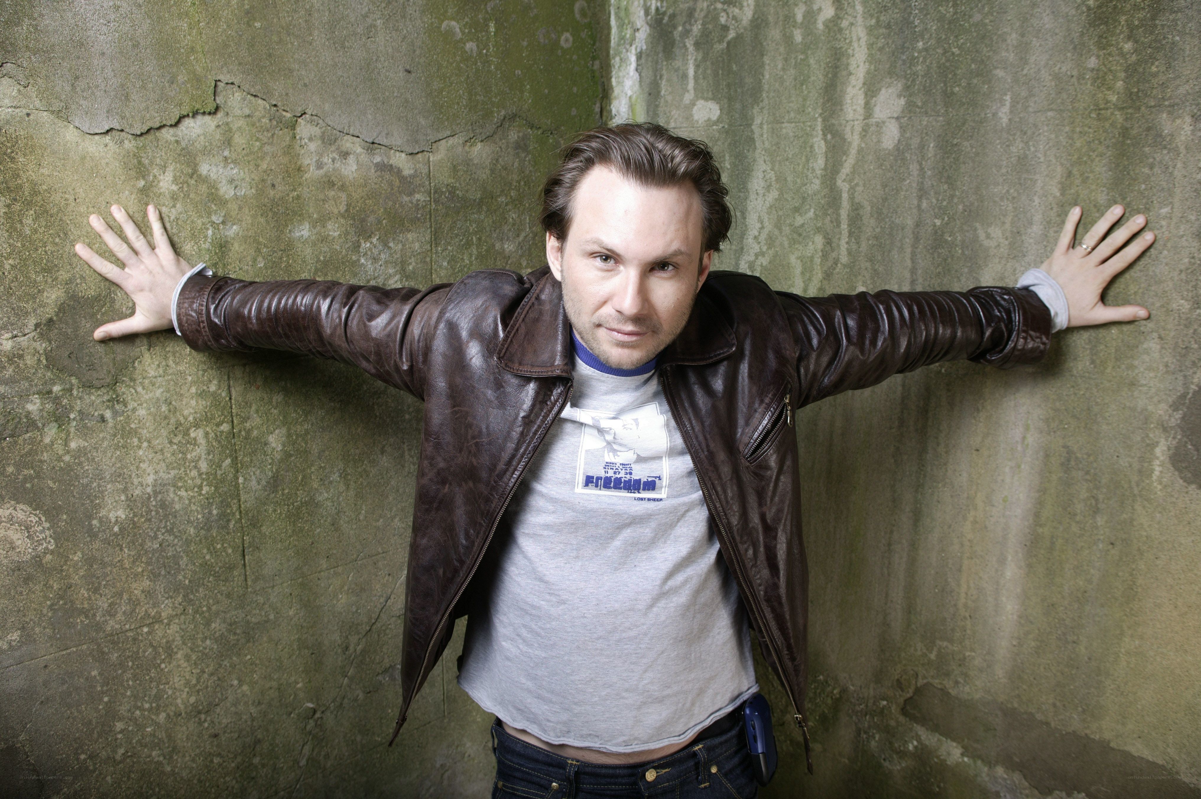 man in leather jacket against wall