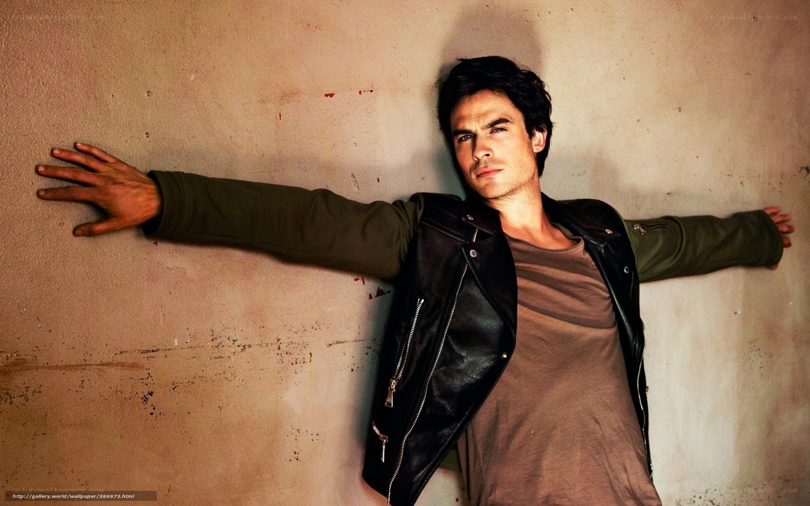 man in leather jacket against wall
