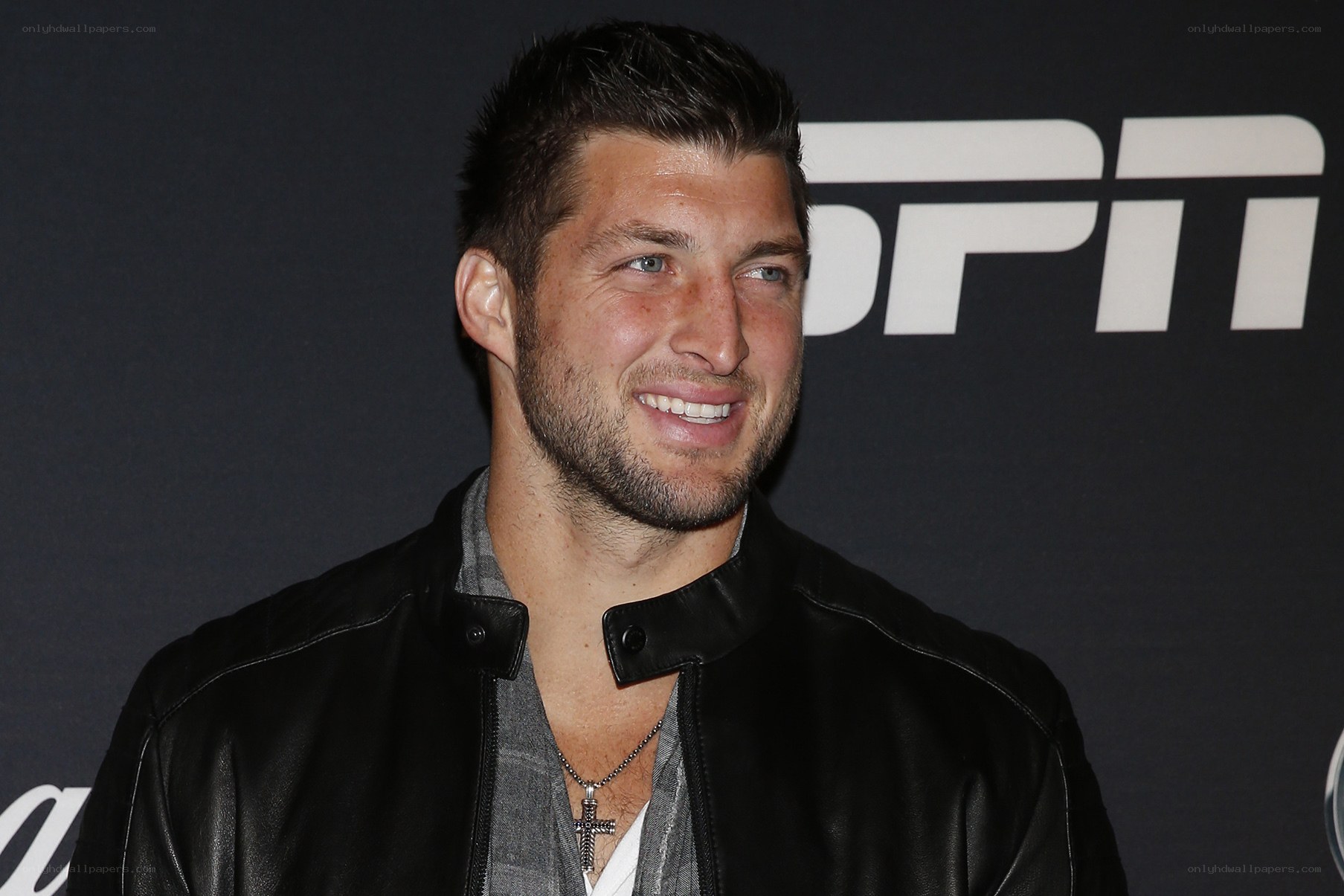 man in leather jacket at event