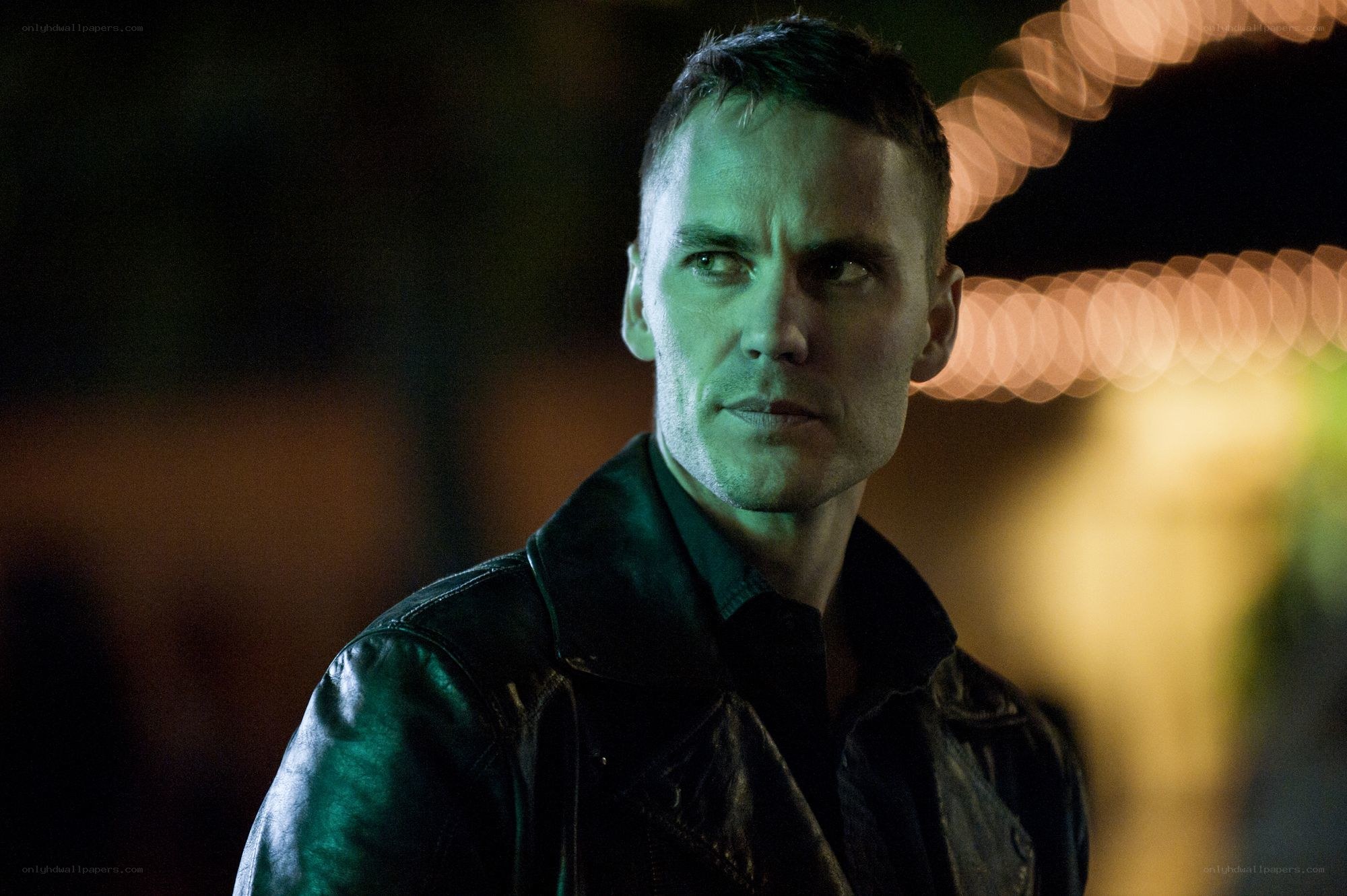 man in leather jacket at night