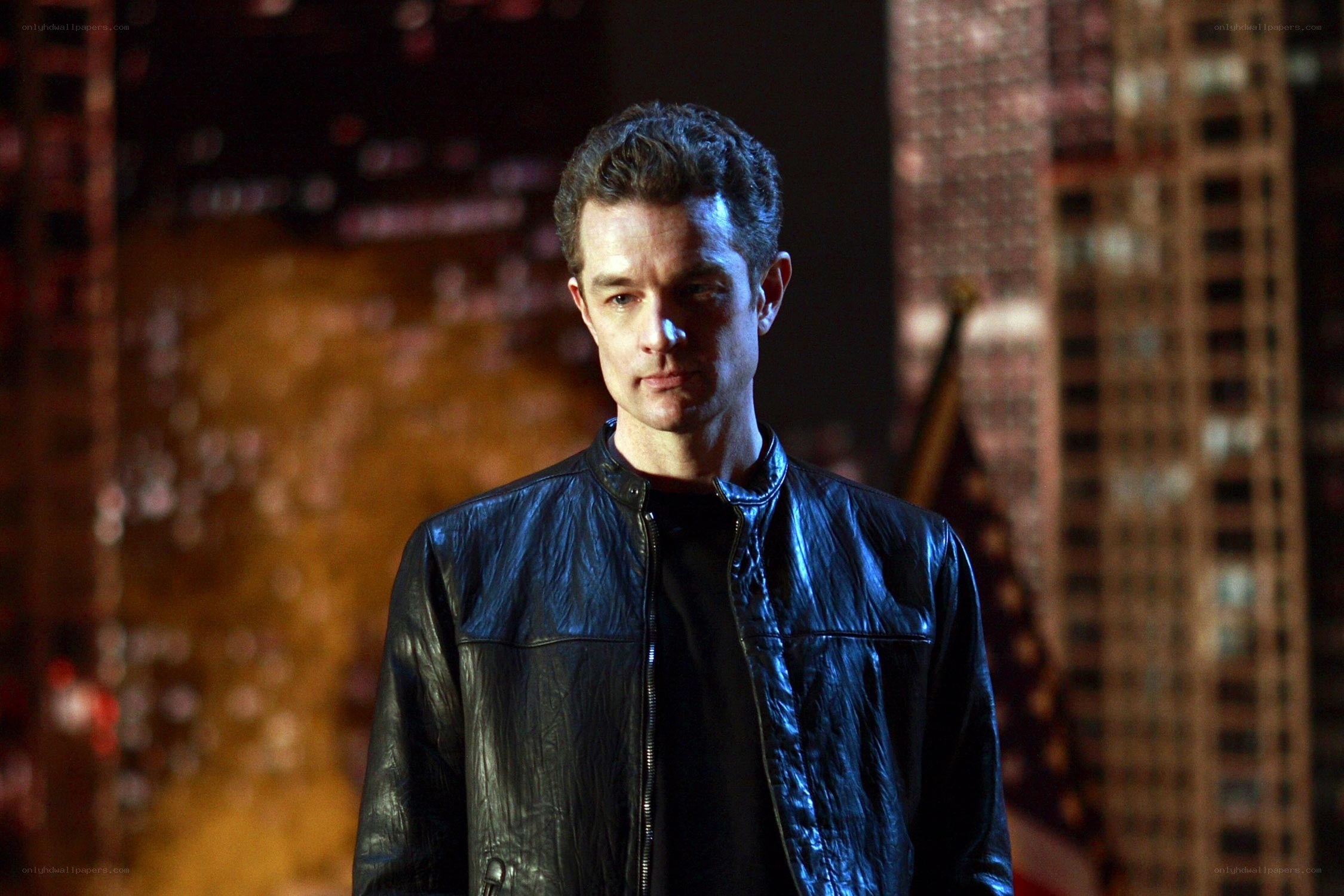 man in leather jacket at night