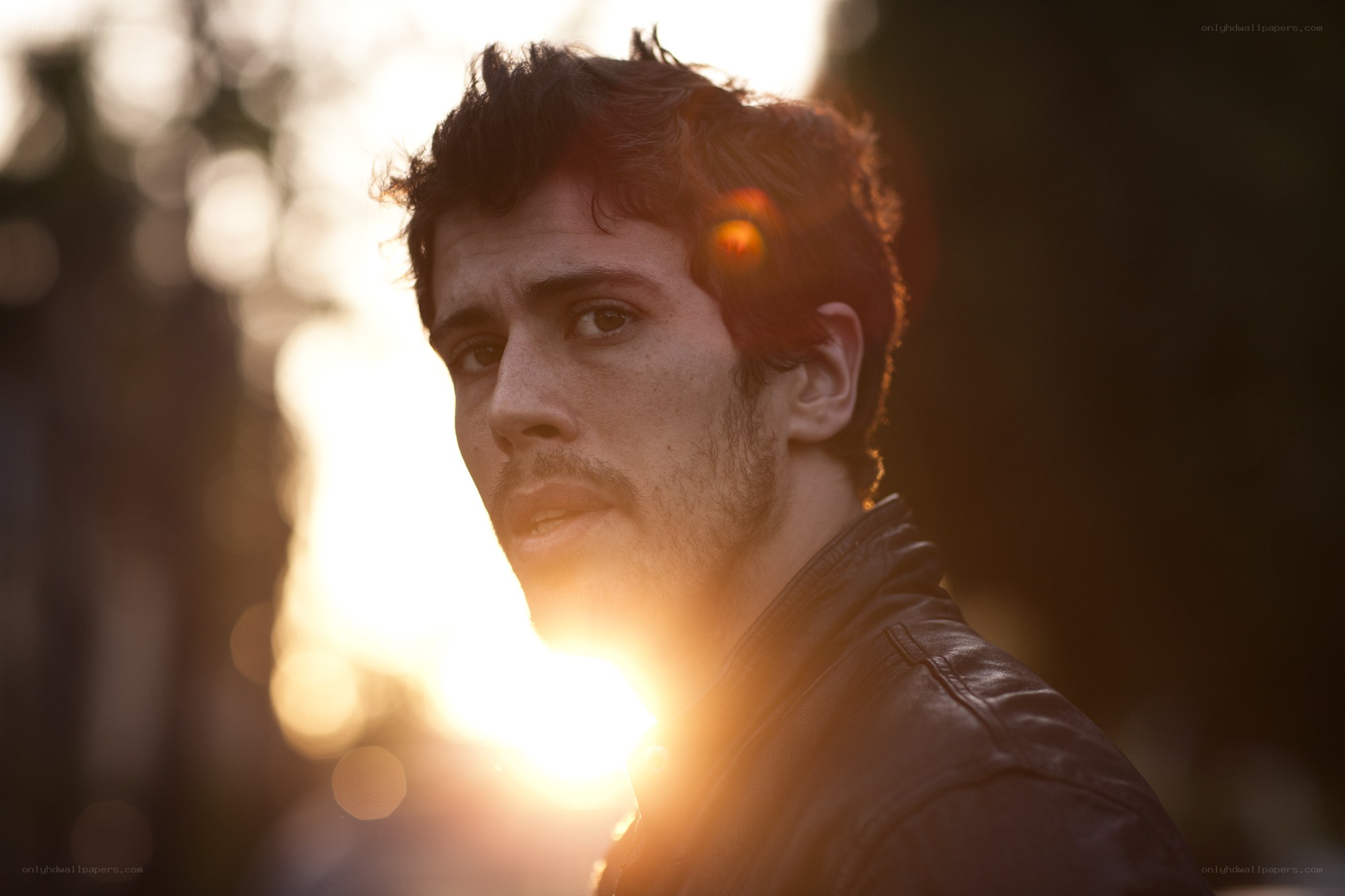 man in leather jacket at sunset