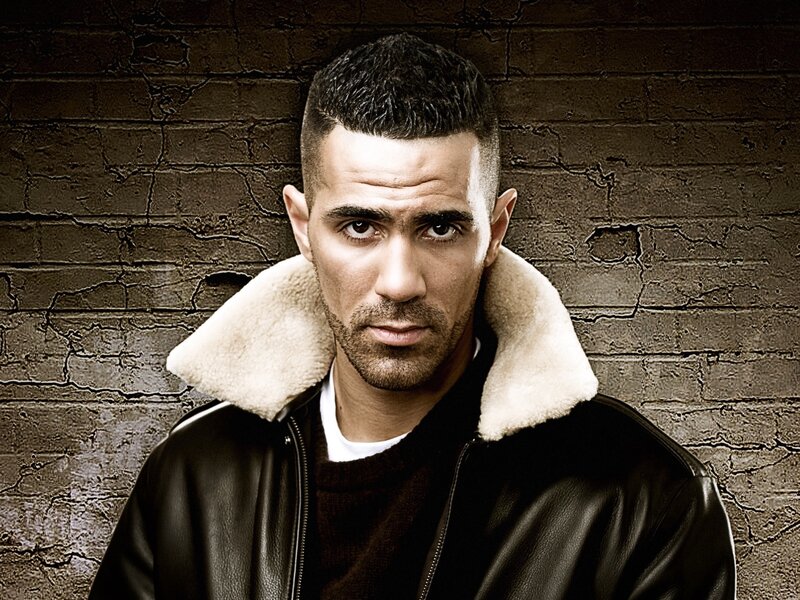 Man in Leather Jacket — Black, Serious, Photograph, Brick Wall