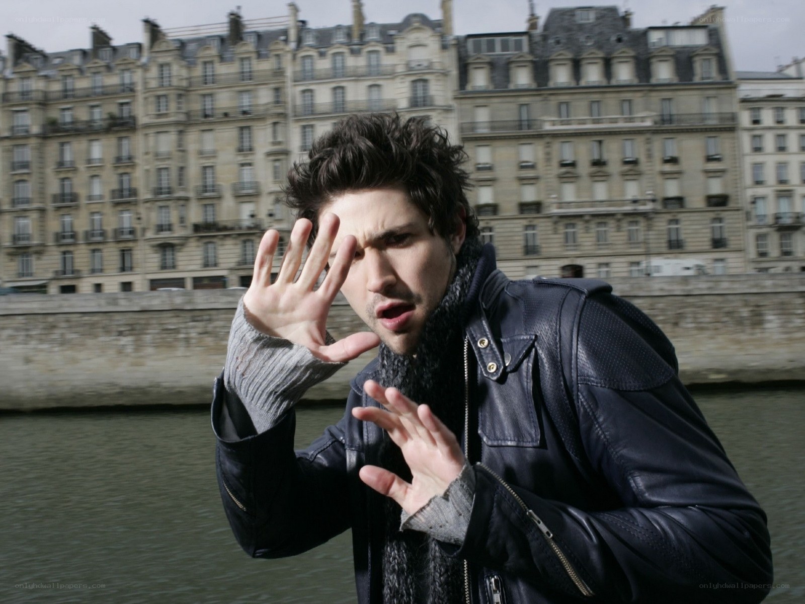 man in leather jacket by river