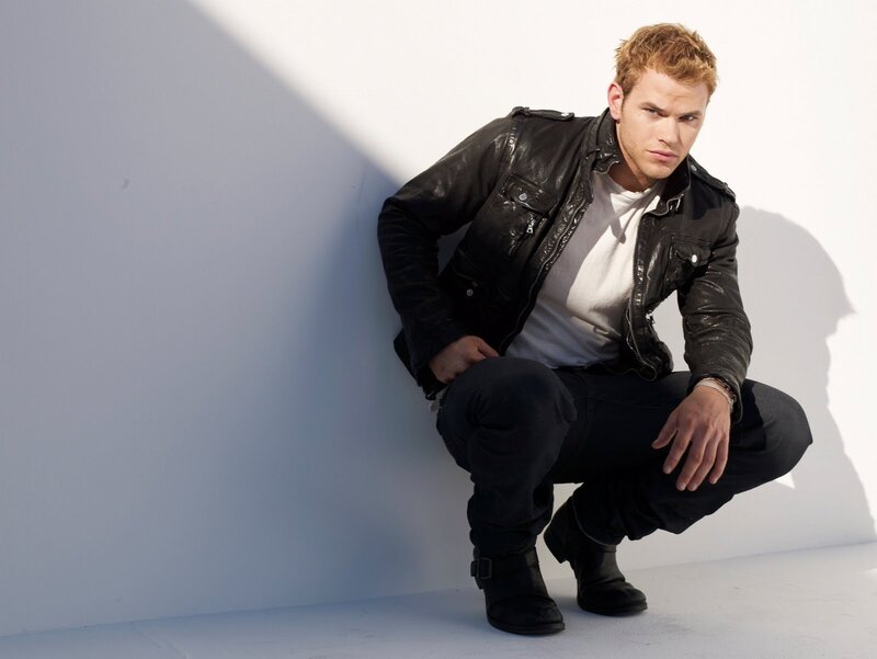 man in leather jacket crouching
