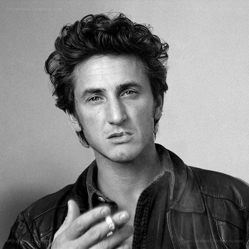 man in leather jacket holding cigarette