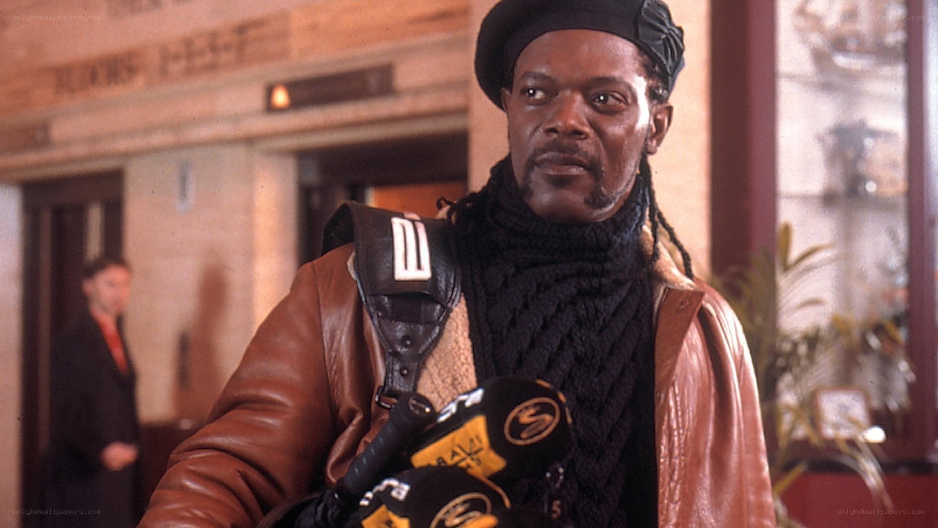 Man in leather jacket holding microphones