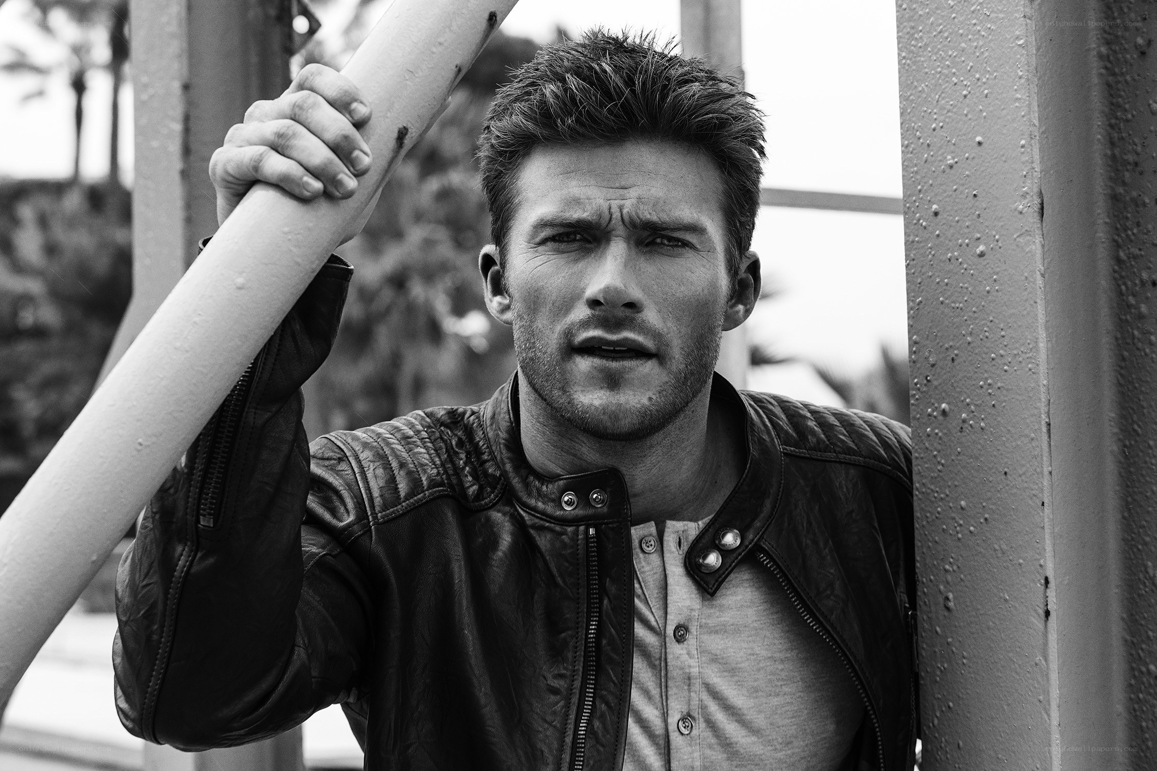 man in leather jacket holding pole