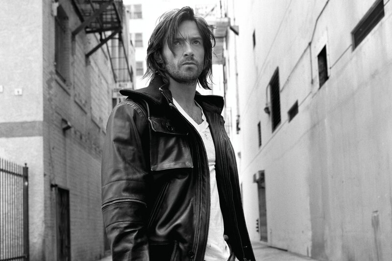 man in leather jacket in alley