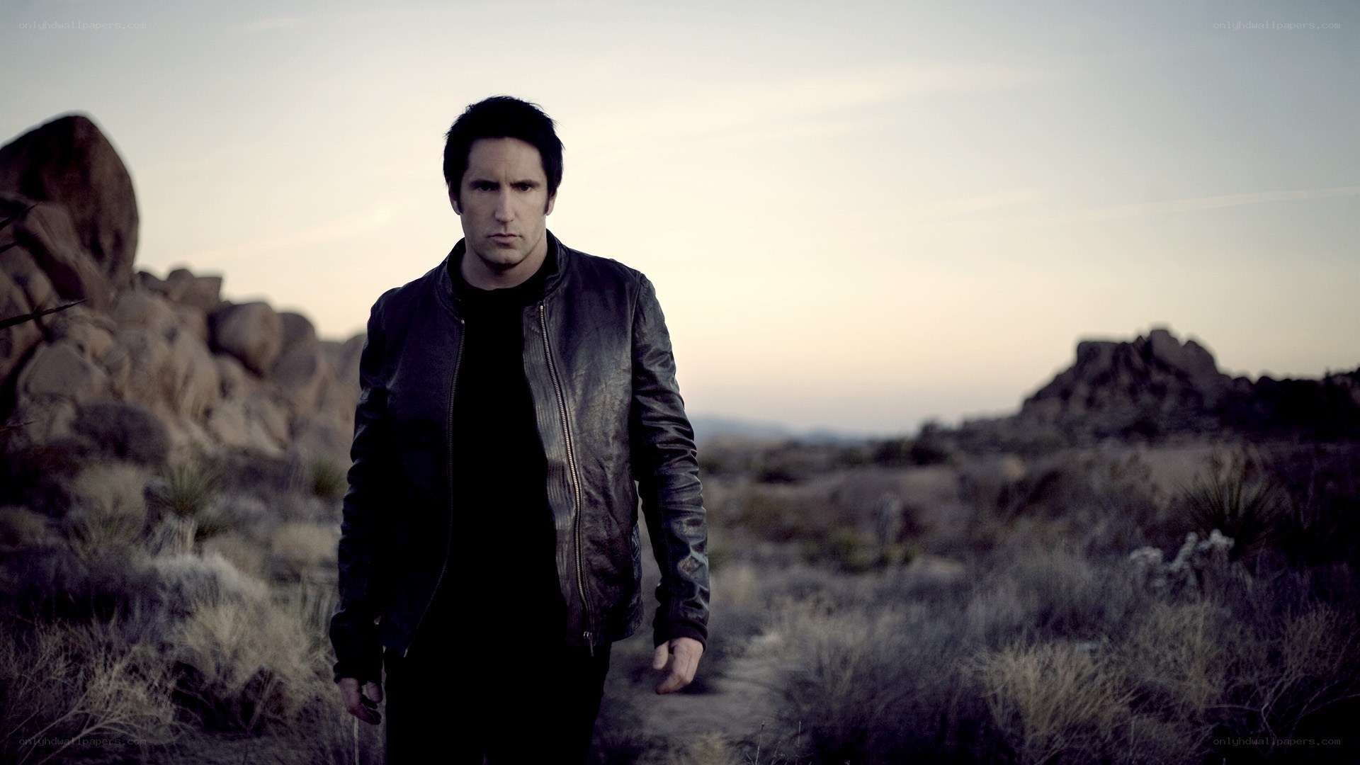 man in leather jacket in desert
