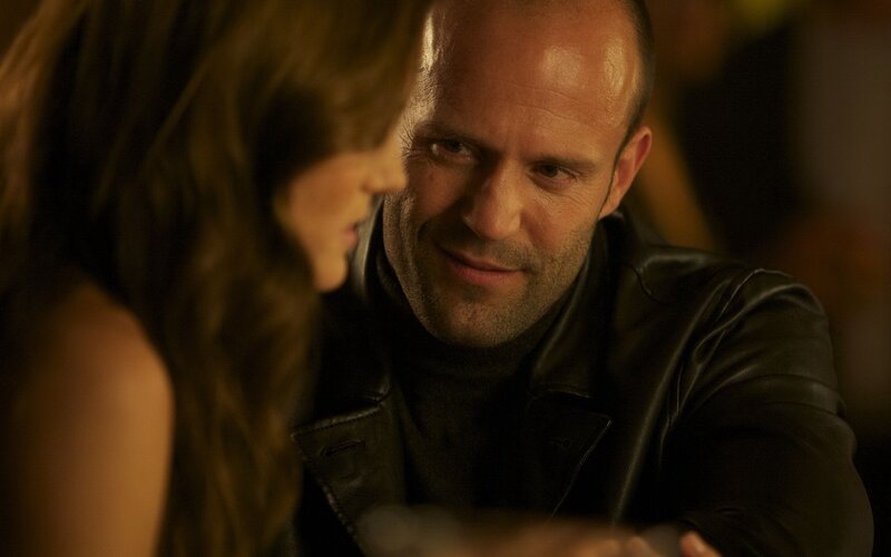 man in leather jacket looking at woman