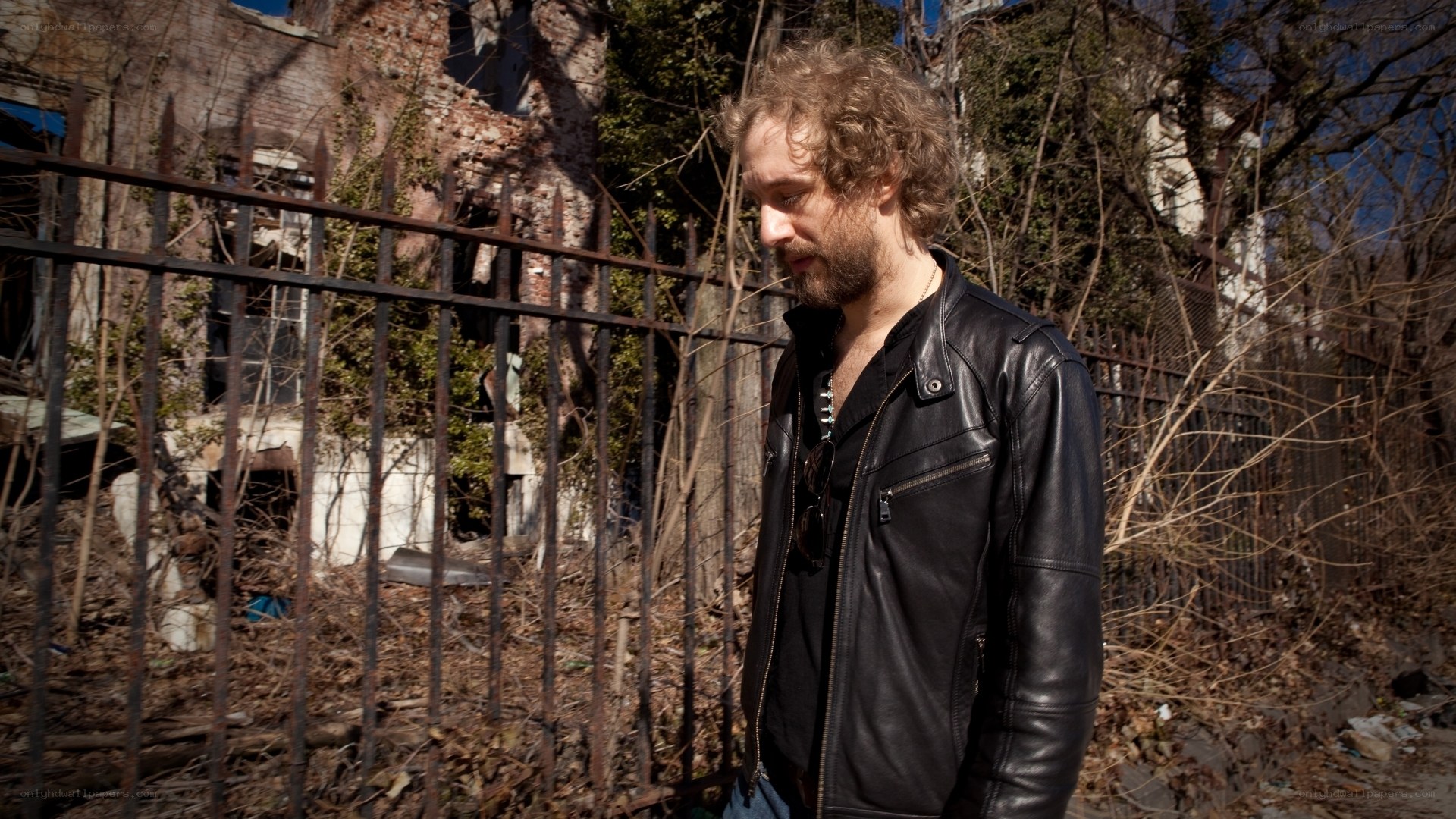 man in leather jacket near ruins