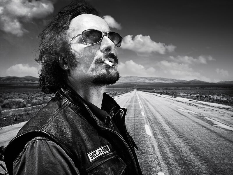 Man in leather jacket on road
