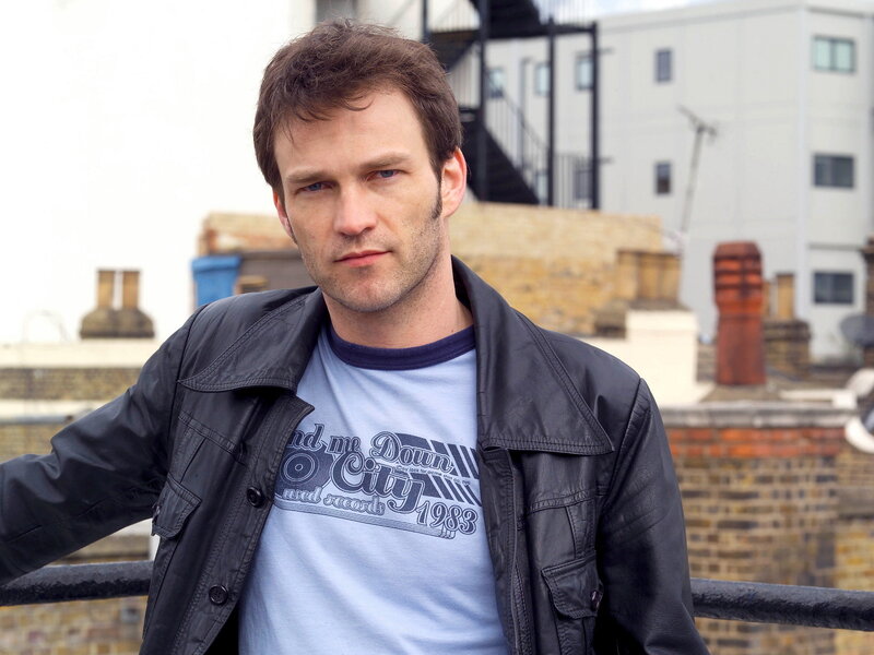 man in leather jacket on rooftop