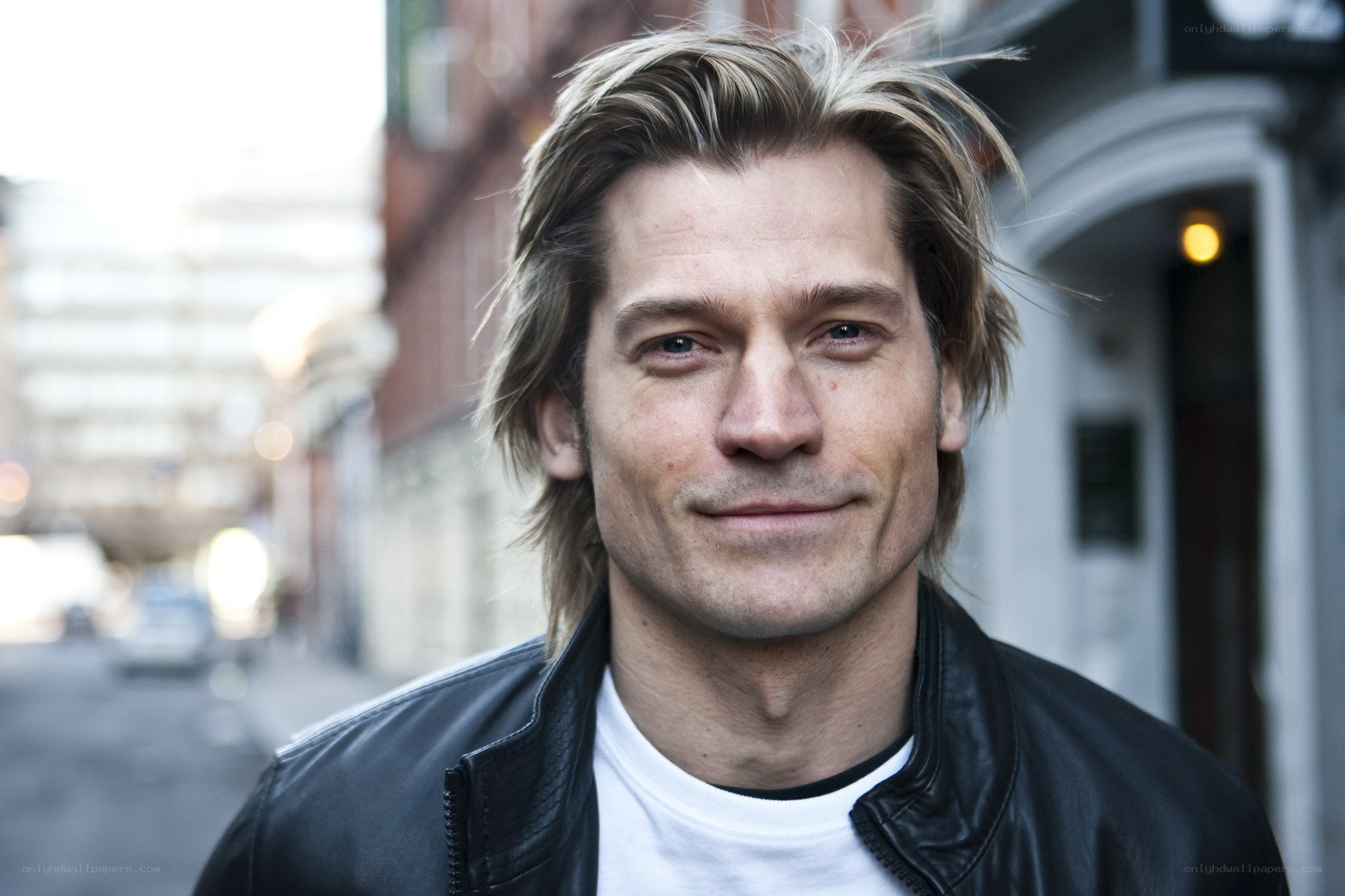man in leather jacket on street